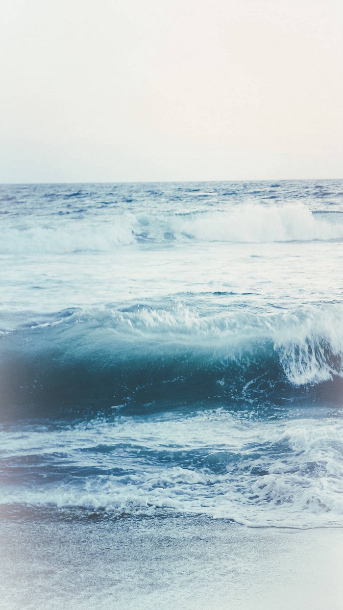 Ocean waves crashing on a sandy beach