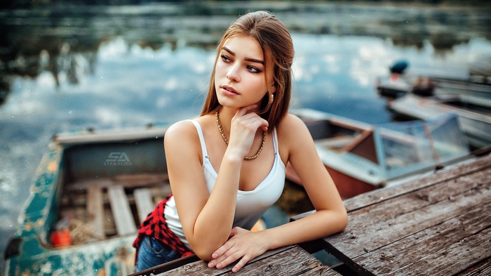 Woman in white tank top and red shirt tied around waist