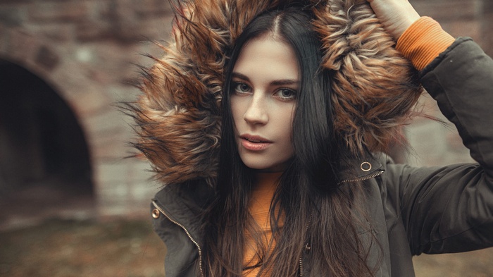 Woman with dark hair wearing a fur-lined hood