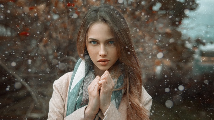 Woman with blue eyes and scarf in snow