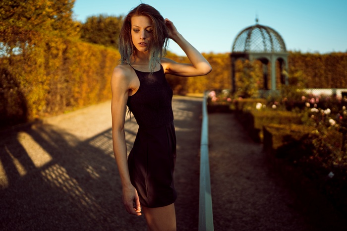 Woman in black dress in a garden