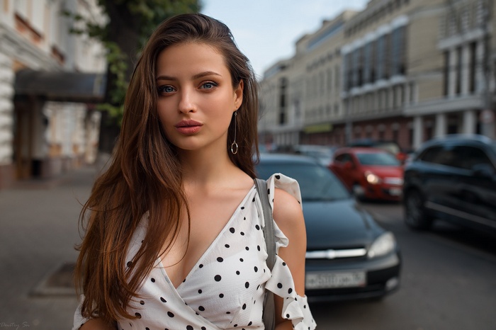 Woman in polka dot dress on a city street
