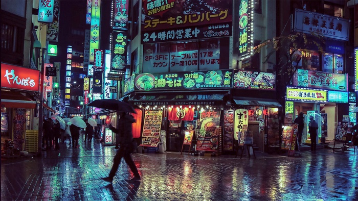 Rainy night in a Japanese city with neon signs