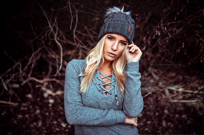 Woman in gray beanie and sweater outdoors