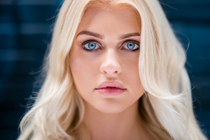 Close-up portrait of a blonde woman with blue eyes