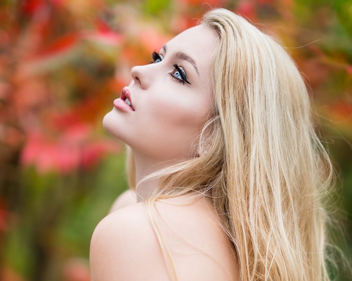 Woman with blonde hair and blue eyes looking up
