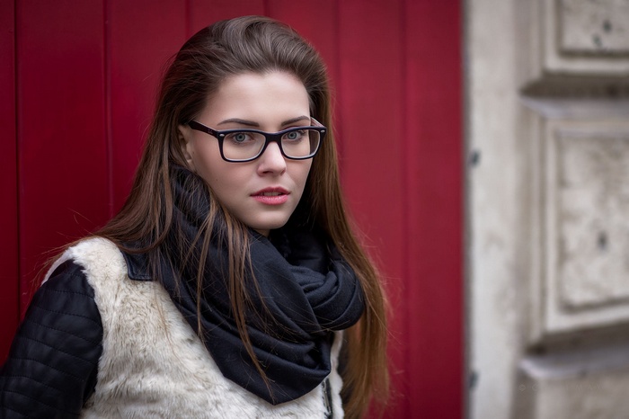 Woman with glasses and scarf outdoors