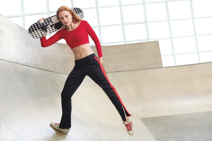 Sophie Turner holding a skateboard in a skatepark
