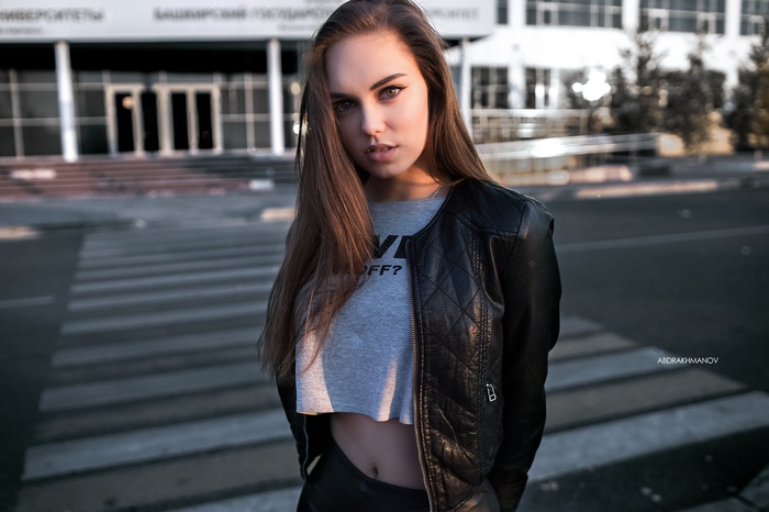 Woman in leather jacket and crop top