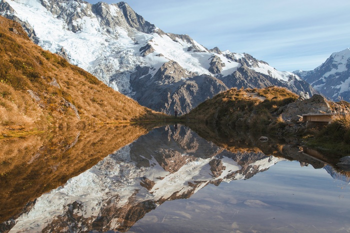 Snow-capped mountains reflected in a calm lake