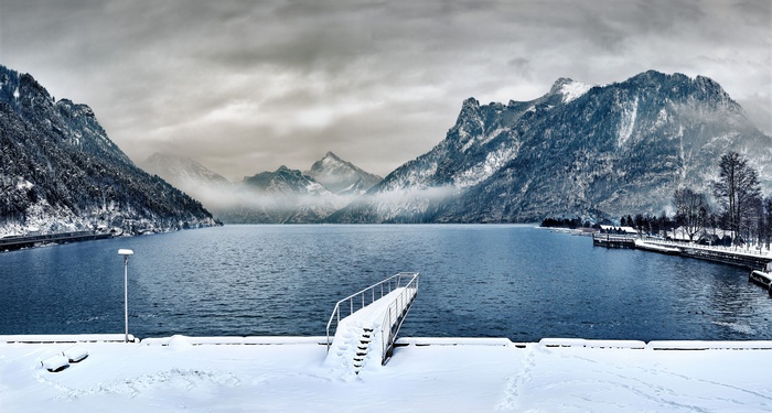 Snowy Mountains Overlooking a Lake with a Pier