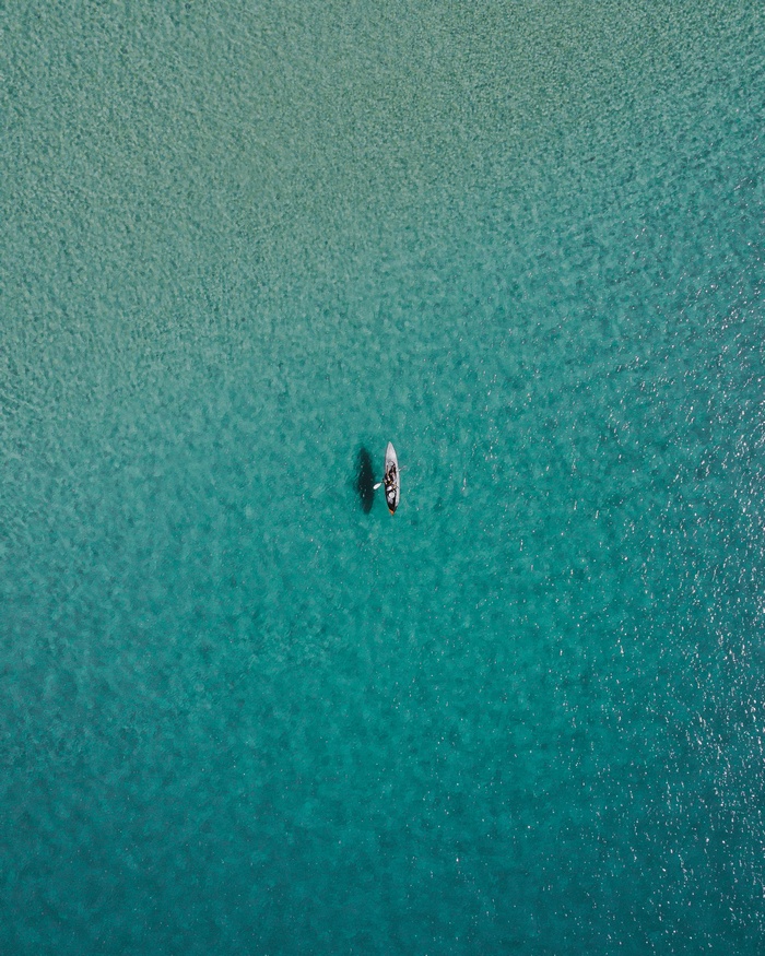 Aerial view of a canoe on turquoise water