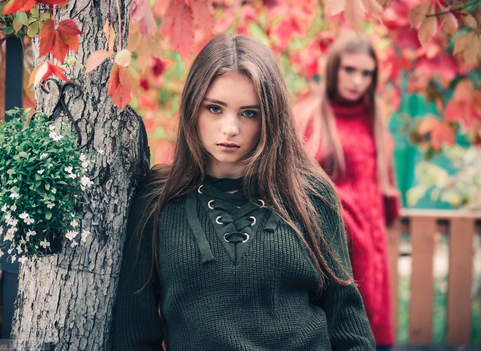Two women in autumn setting, one in foreground