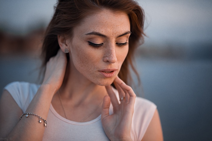 Woman with freckles and closed eyes, portrait