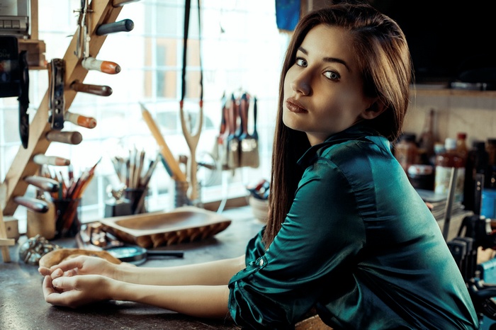 Woman with long brown hair in a workshop