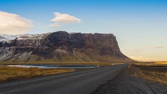 Road leading to a large mountain range