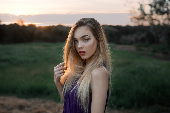 Woman with blonde hair at sunset