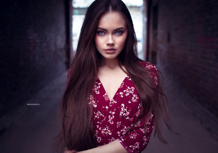Woman with long brown hair in a floral dress