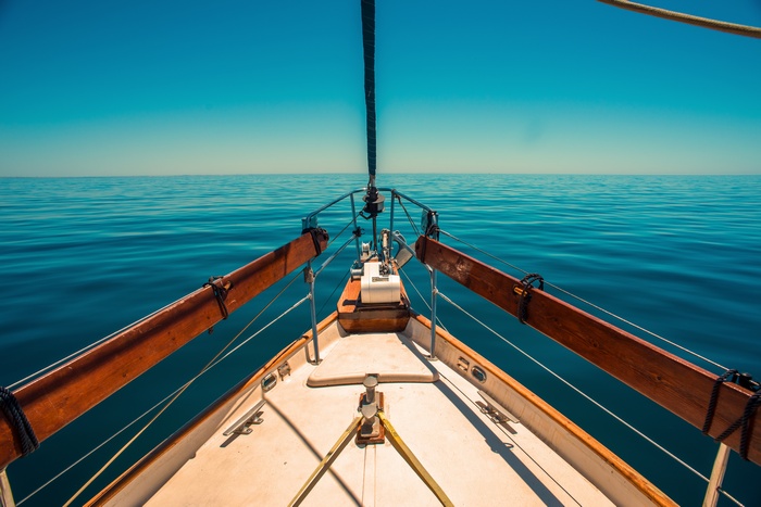 Sailing on a calm blue sea under a clear sky