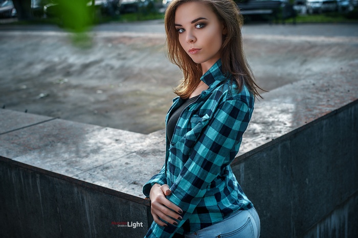 Woman in plaid shirt and jeans outdoors