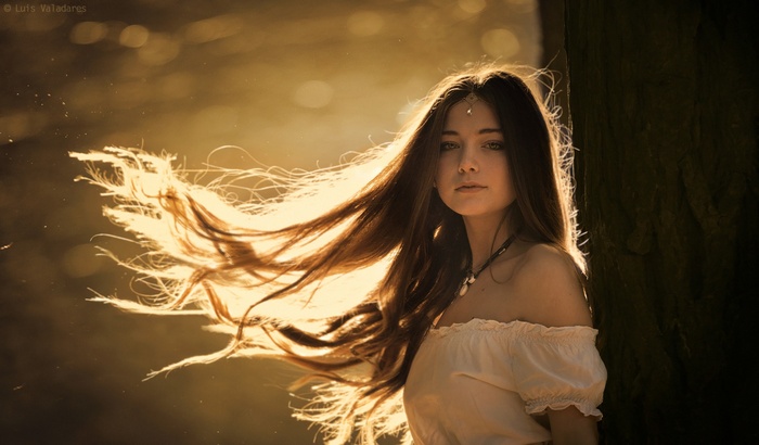 Woman with long hair in sunlight