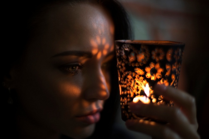 Woman holding a candle lantern