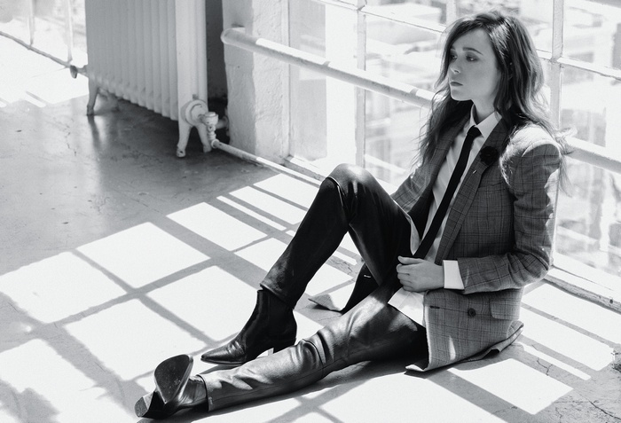 Elliot Page in a suit sitting on the floor