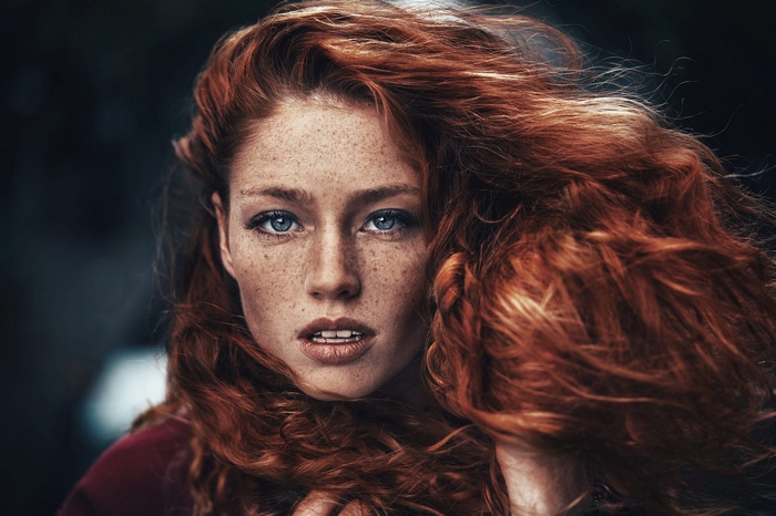 Portrait of a Redhead Woman with Freckles and Blue Eyes