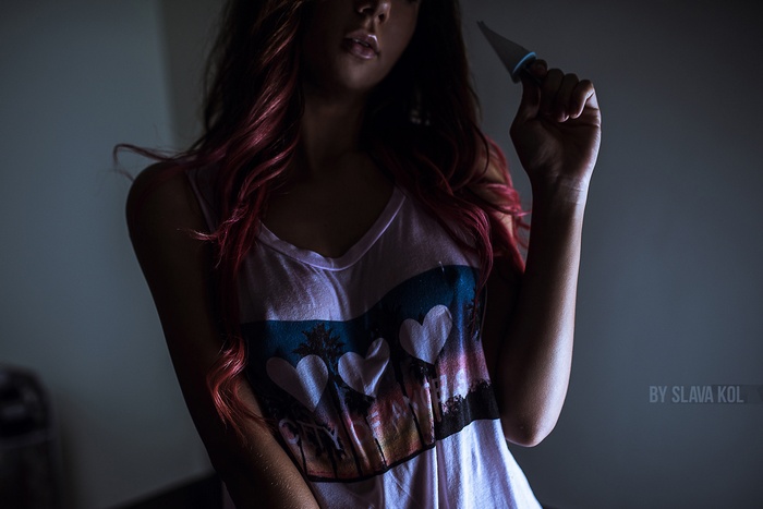 Woman with red hair holding a knife