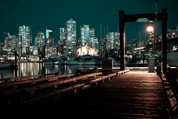 Night cityscape with pier and boats