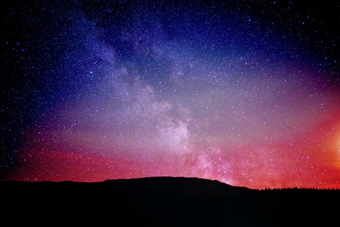 Night sky with Milky Way and silhouette of hills