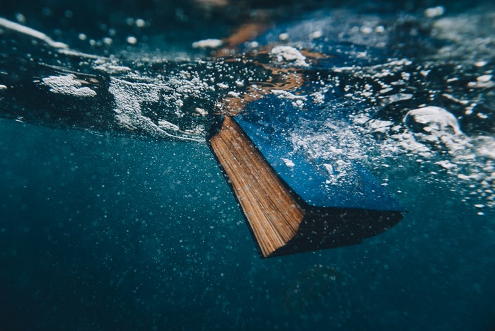 Book submerged underwater with bubbles