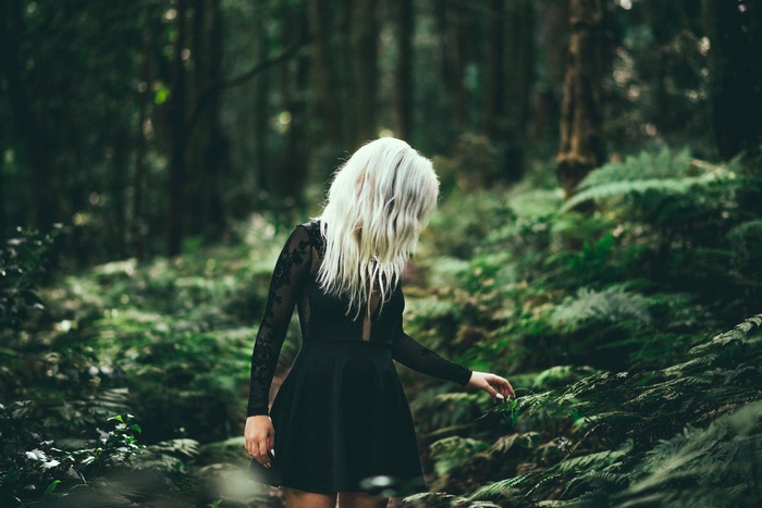 Woman in black dress in a forest