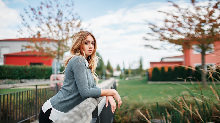 Woman leaning on a railing outdoors