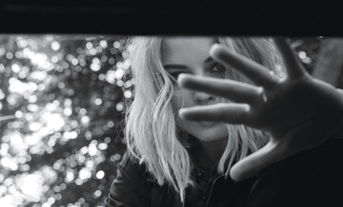 Margot Robbie with hand in front of face