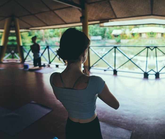 Woman practicing yoga in an open-air studio