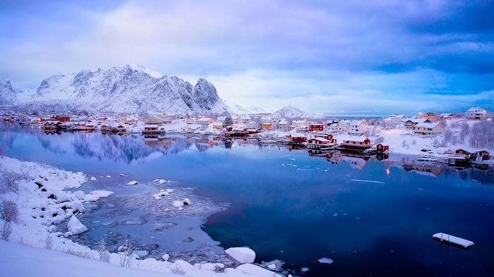 Snowy village on the water in Norway