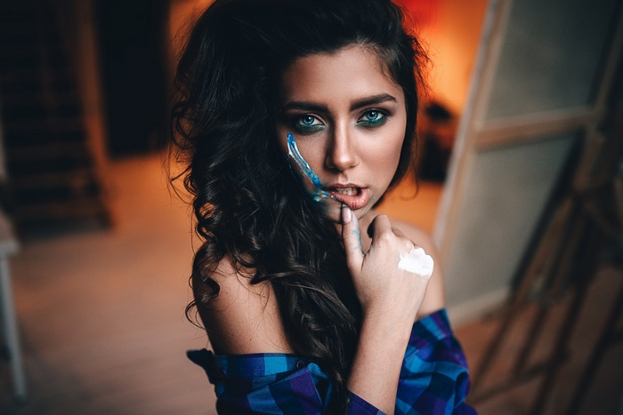 Woman with blue eyes and paint on face