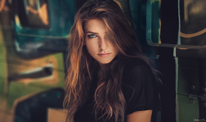 Woman with long brown hair and green eyes