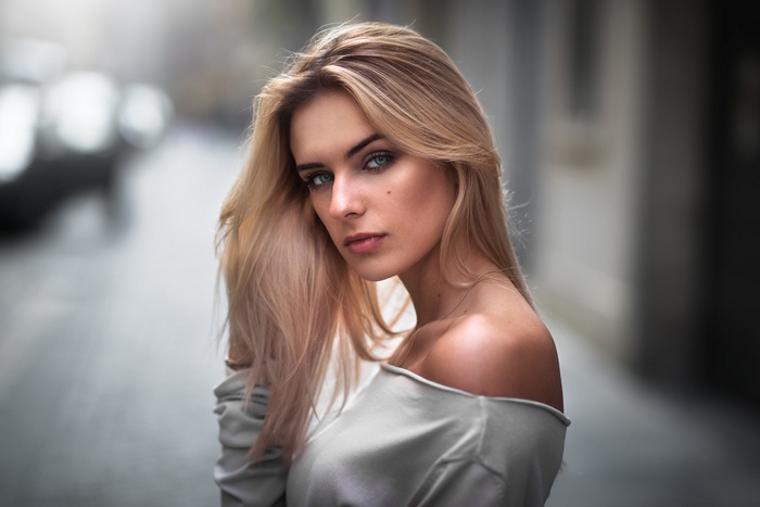Blonde woman with off-the-shoulder top outdoors