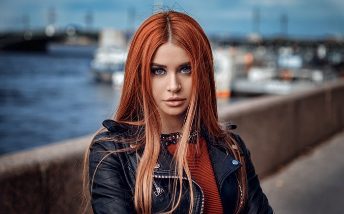 Woman with red hair wearing a leather jacket