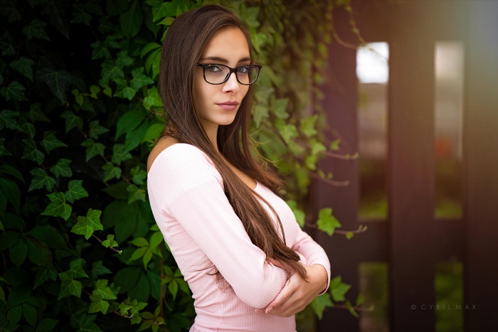 Woman with long brown hair and glasses