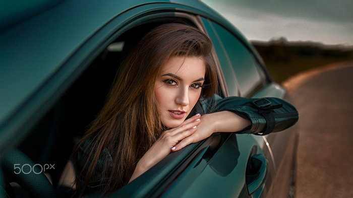 Woman leaning out of a car window