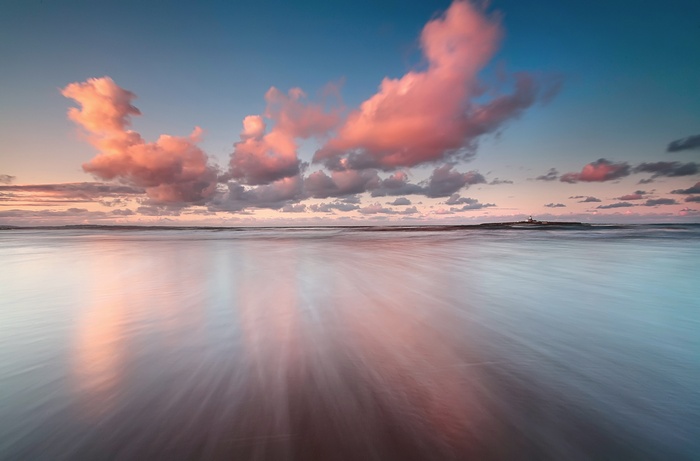 Pink clouds over the sea at sunset