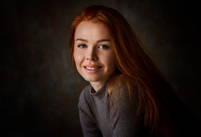 Portrait of a smiling redhead woman with blue eyes