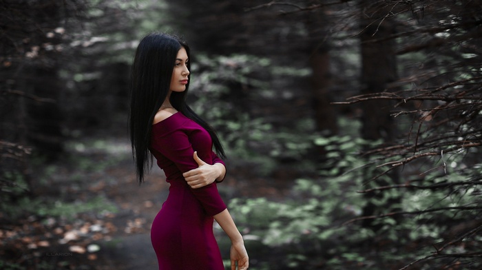 Woman in a purple dress in a forest