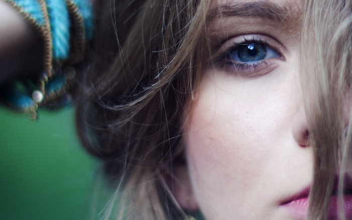 Close-up of a woman with blue eyes and blonde hair