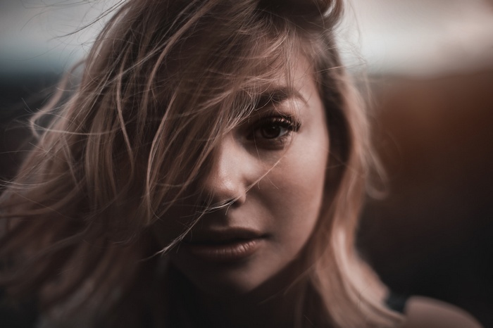 Woman with hair covering her face