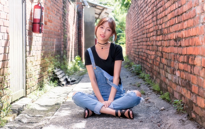 women outdoors, Asian, sitting, urban, legs crossed, women