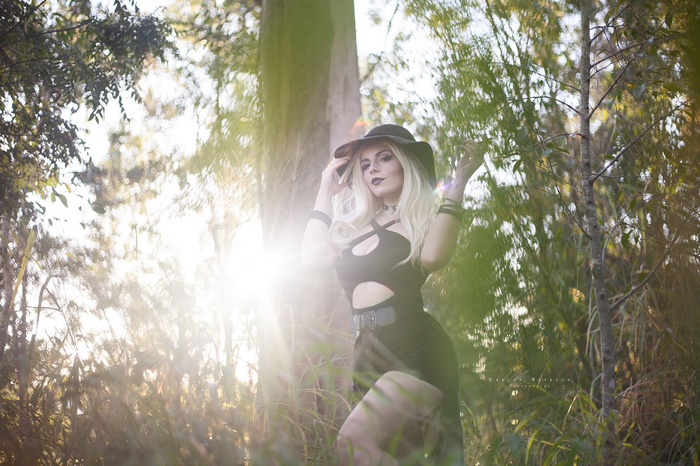 Katyuska Moonfox in a black outfit and sun hat outdoors